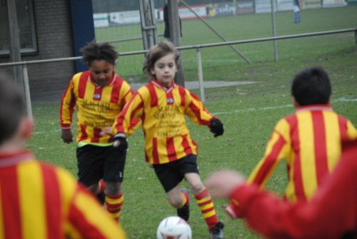 Young kids playing soccer tend to follow the ball. They still need to learn how to perform as a team..jpg